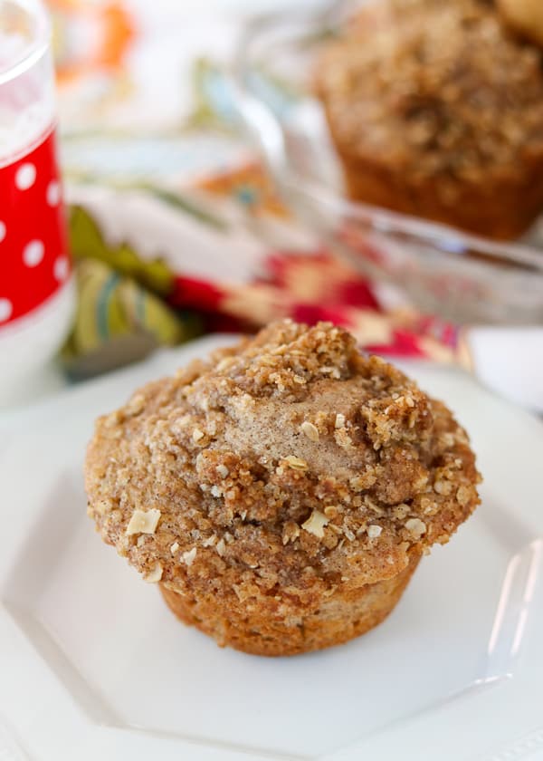 One whole Apple Streusel Muffin on a plate.