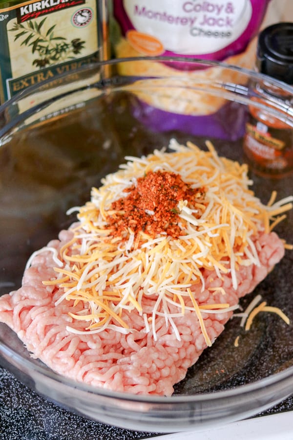 Chipotle seasoning, shredded cheddar cheeses and ground pork make up this super easy Cheesy Spiced Pork Burgers recipe.