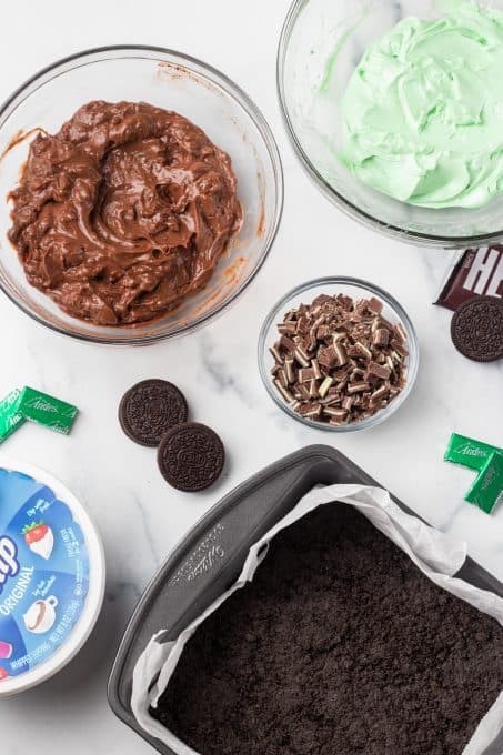 Cookie crust and ingredients for no bake mint dream bars.