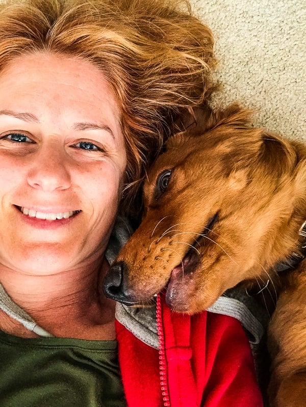 Lynne Feifer snuggling with Logan the Golden Dog.