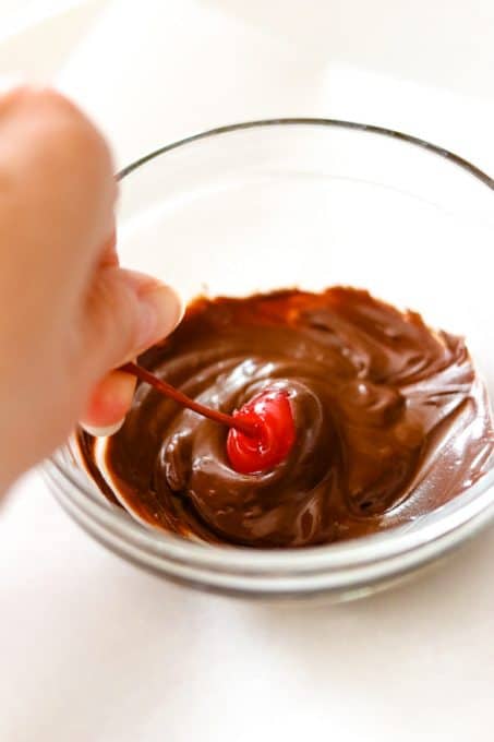 A chocolate covered cherry to garnish a cup of Chocolate Covered Cherry Hot Chocolate.