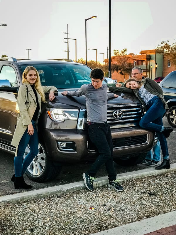 Family at the hood of the 2019 Toyota Sequoia Platinum.