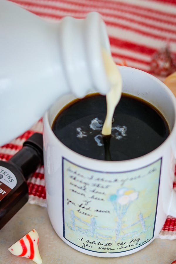 Pouring Peppermint White Chocolate Coffee Creamer into coffee.