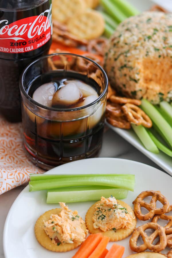 Buffalo Chicken Cheese Ball on crackers on a plate.