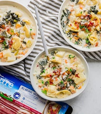 Bowls of One Pot Bacon and Tortellini Zuppa Toscana, and Pure Farmland Bacon.