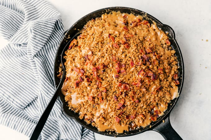 Bacon Caramel Apple Crisp with Pure Farmland Bacon in a cast iron skillet.