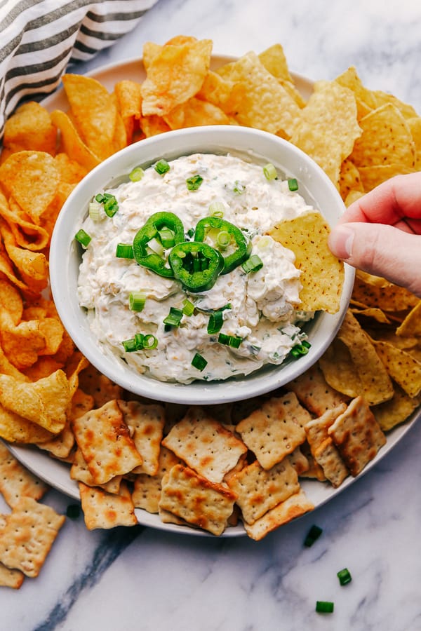 Jalapeño Ranch Dip in a bowl surrounded by chips and crackers.