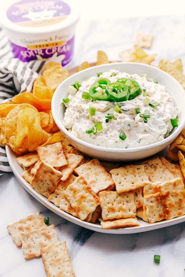 A plate filled with crackers, Chips, Jalapeño Ranch Dip made with Shamrock Farms Sour Cream.