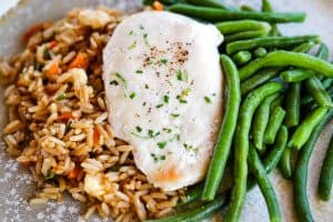 A balanced meal with Schwan's Vegetable Fried Rice, Chicken Breast Fillet and MicroSteam Whole Green Beans plated.