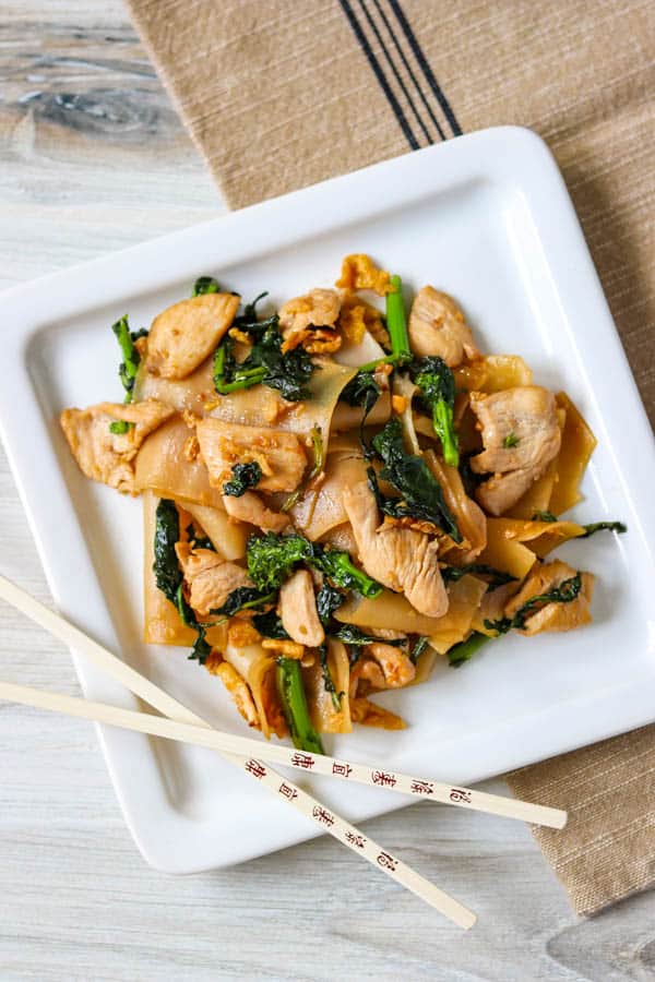 A plate of Pad See Ew with chopsticks.