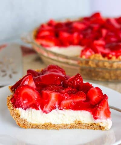 A slice of Strawberry Pretzel Pie with the pie in the background.