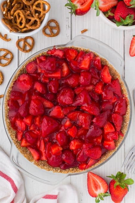 Strawberries top a cheesecake pie.