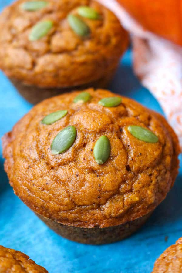 A Dairy-Free Pumpkin Muffin topped with pepitas.
