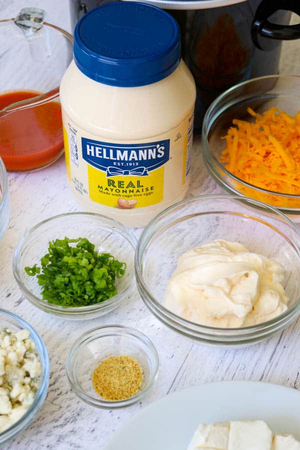 Hellmann's Mayonnaise and the ingredients for the Slow Cooker Buffalo Chicken Dip. Hellmann's Mayonnaise and the ingredients for the Slow Cooker Buffalo Chicken Dip.