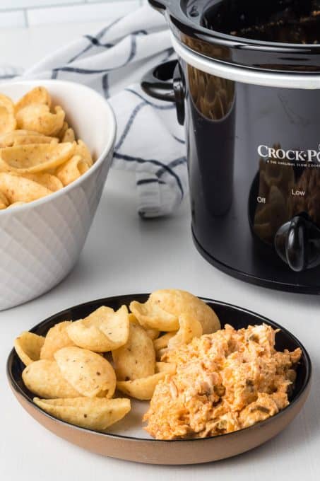 A chicken appetizer made with buffalo sauce in the slow cooker.