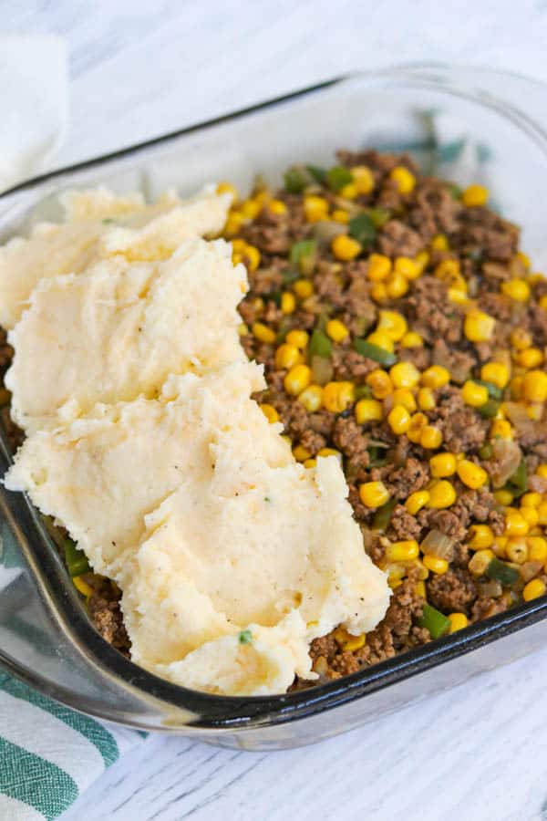 Preparing to spread the seasoned mashed potatoes on the Easy Shepherd's Pie Recipe.