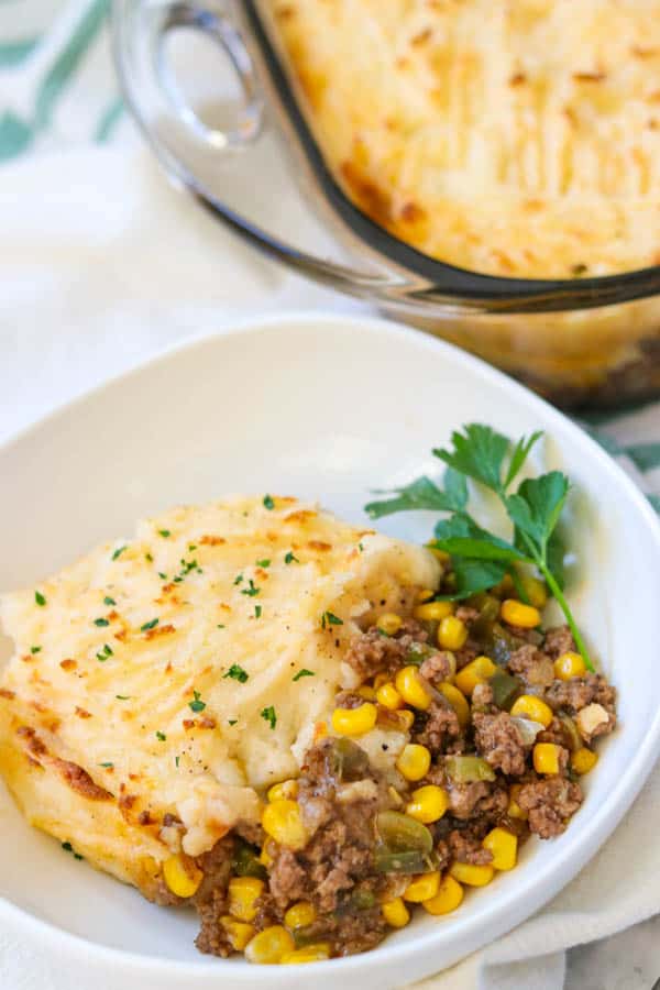 Easy Shepherd's Pie Recipe garnished with a sprig of fresh parsley.