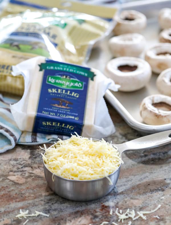 Grated Kerrygold Skellig cheese and Kerrygold Shredded Savory Cheddar for Cheesy Sausage Stuffed Mushrooms.