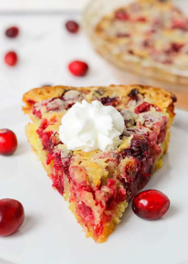 A slice of Easy Cranberry Pie Recipe topped with whipped cream.