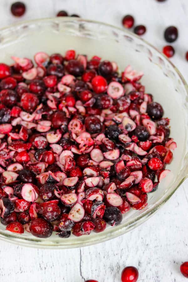 Pie plate of whole and chopped cranberries for Easy Cranberry Pie Recipe.