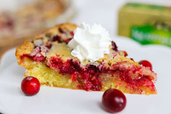 A slice of Easy Cranberry Pie Recipe topped with whipped cream and cranberries.