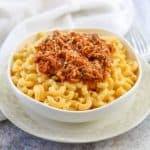 A bowl of BBQ Pork Mac & Cheese on a plate.