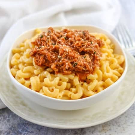 A bowl of BBQ Pork Mac & Cheese on a plate.