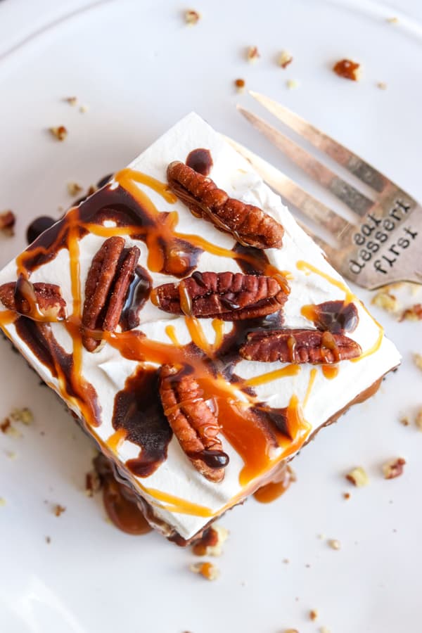 Caramel, chocolate and pecans on top of No Bake Turtle Dream Bars.