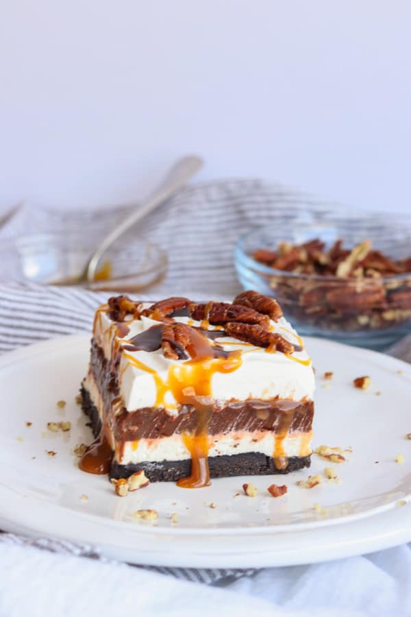 Easy No Bake Turtle Dream Bars Caramel Sauce, Chocolate sauce and pecans on top of No Bake Turtle Dream Bars.