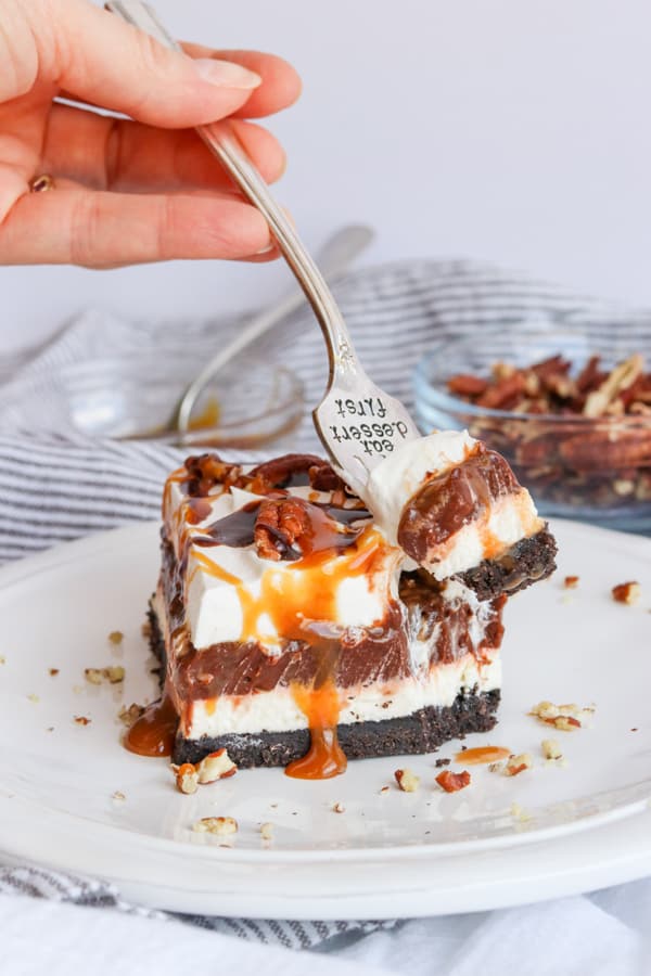 A bite of No Bake Turtle Dream Bars on a fork. A bite of No Bake Turtle Dream Bars.