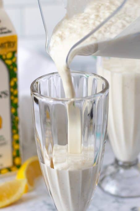 Pouring a Lemon Milkshake into a tall glass.