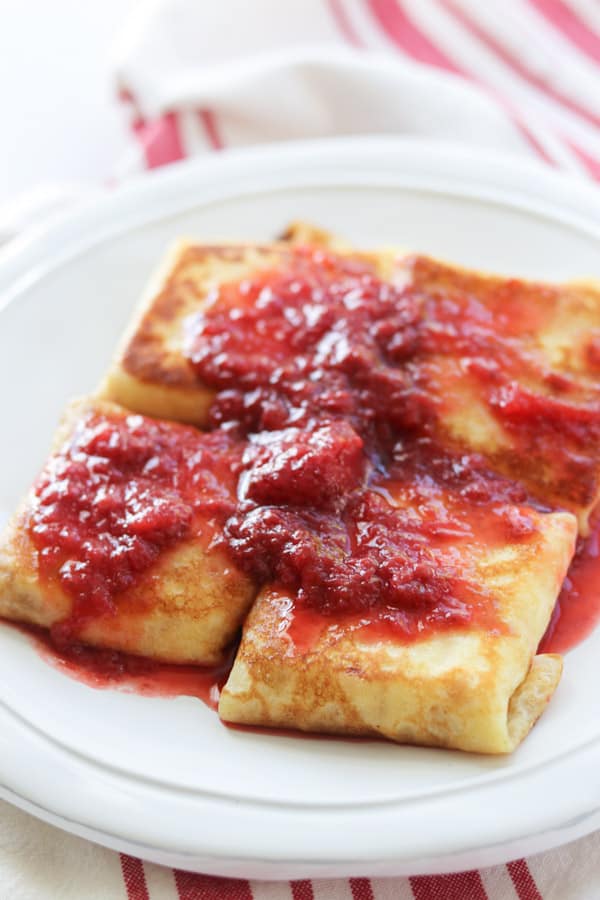 The ultimate cheese blintzes recipe topped with an easy 3-ingredient strawberry sauce.