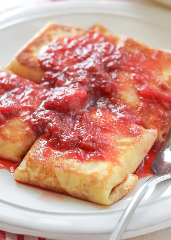 The ultimate Cheese Blintzes covered in strawberry sauce.