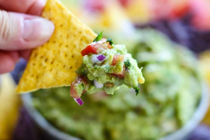 Homemade guacamole on a tortilla chip.