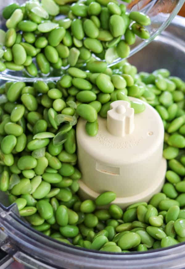 Edamame poured into a food processor.