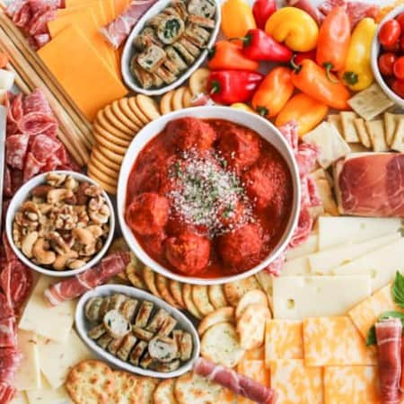 An assortment of meats, cheeses, crackers, nuts, veggies, meatballs and more perfect for snacking, entertaining and dinner!