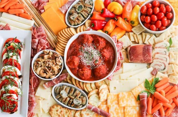 An assortment of meats, cheeses, crackers, nuts, veggies, meatballs and more perfect for snacking, entertaining and dinner!