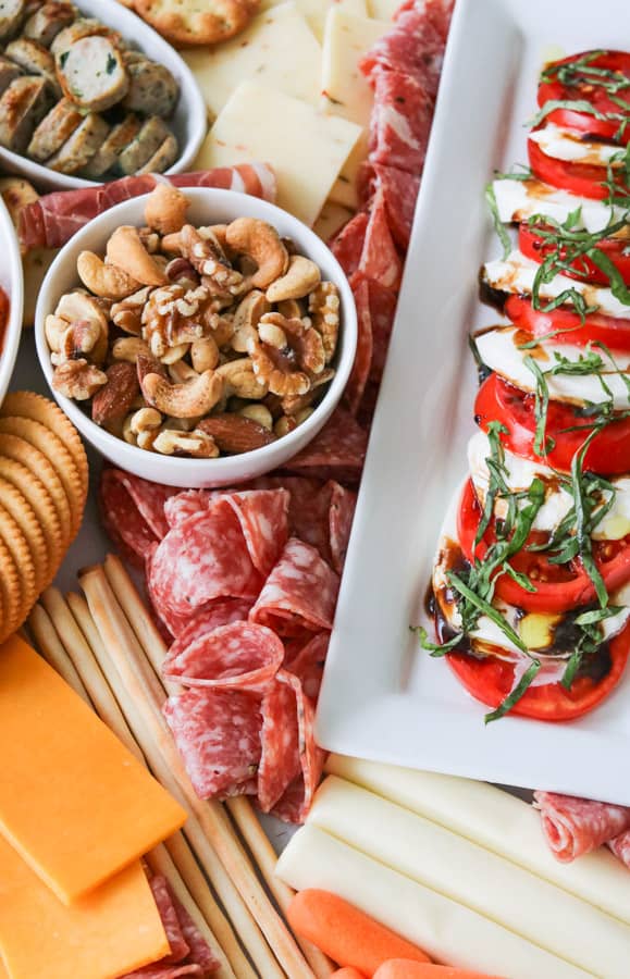 Nuts, crackers, cheese, salame, caprese.