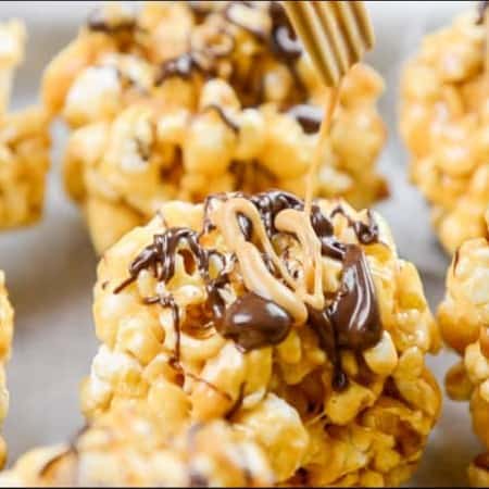 Drizzling PB2 Organic Powdered Peanut Butter on a popcorn ball.