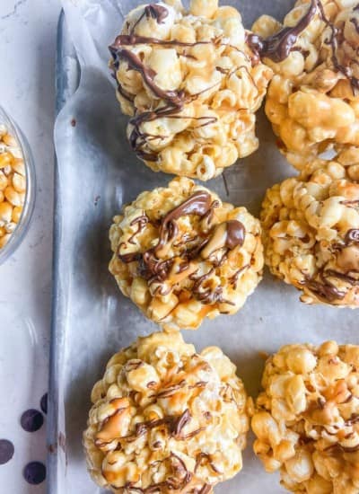 Peanut Butter Popcorn Balls drizzled with chocolate and PB2 Organic Powdered Peanut Butter.