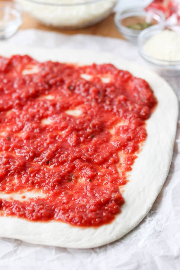 Pizza sauce on pizza dough.