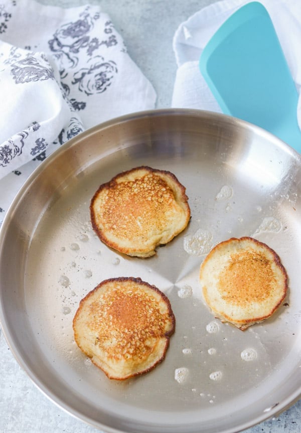 A skillet with cooked griddle cakes.