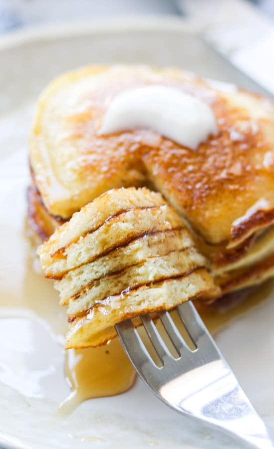 A bite of griddle cakes on a fork.