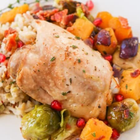 A plate of cooked chicken and vegetables.