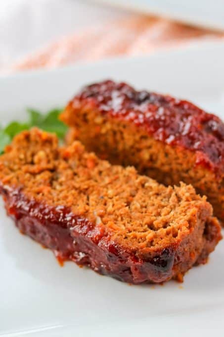 Two slices of meatloaf on a plate.