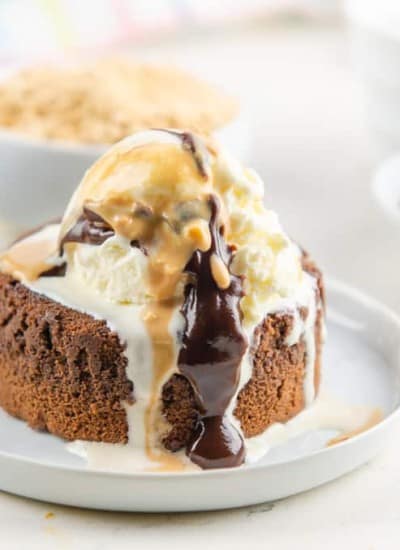 Peanut Butter Chocolate Lava Cake topped with ice cream and peanut butter and chocolate drizzle.