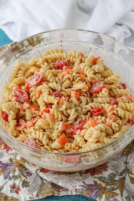 Pasta salad ready to be refrigerated.
