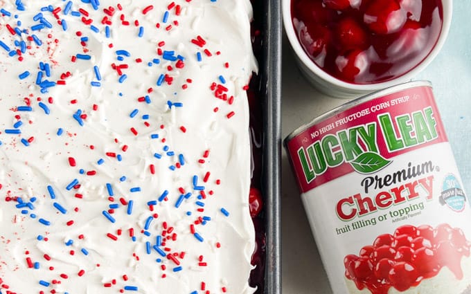 Top of a cake with red, white, and blue sprinkles.