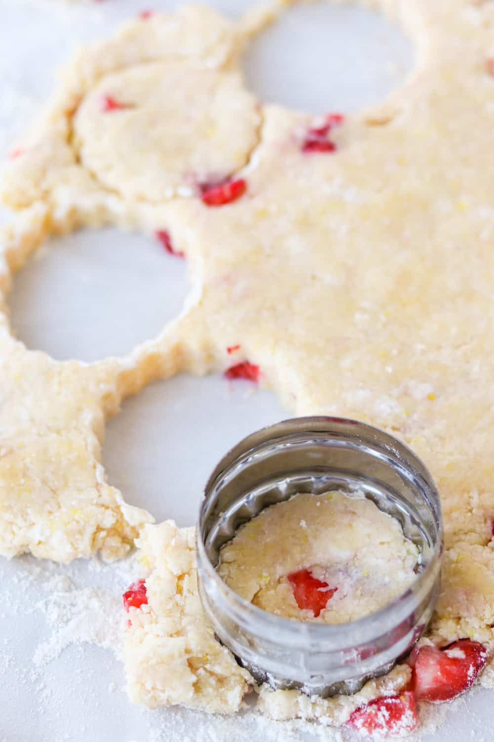 Cutting out scones with strawberries.