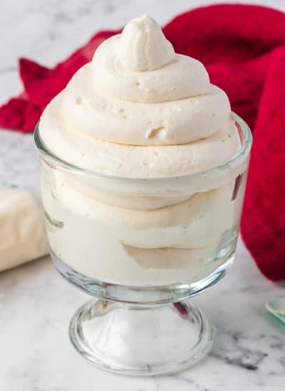 Stabilized Whipped Cream - a great Cool Whip substitute in a dish with a red napkin in the background.